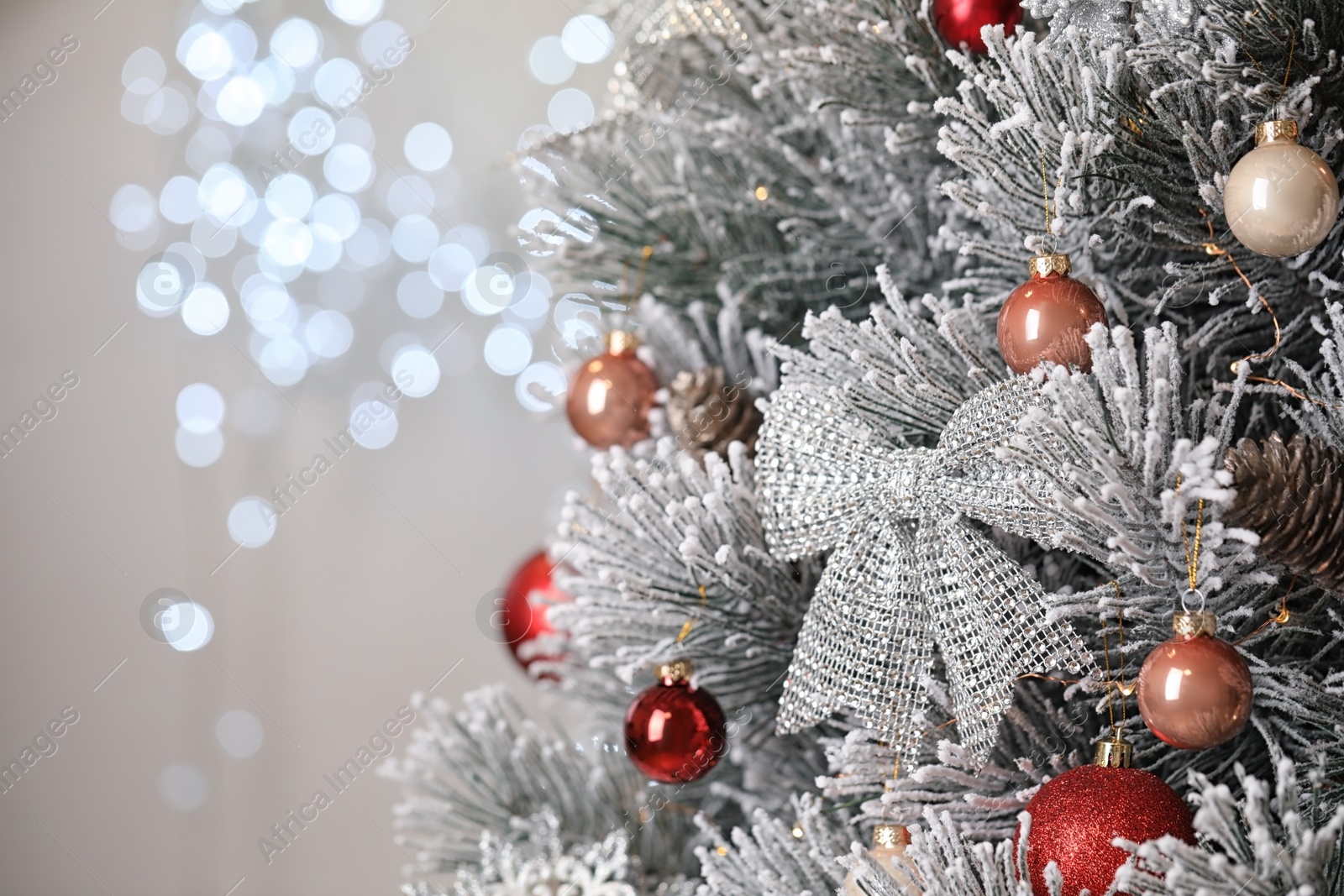 Photo of Beautiful Christmas tree with festive decor against blurred lights on background. Space for text