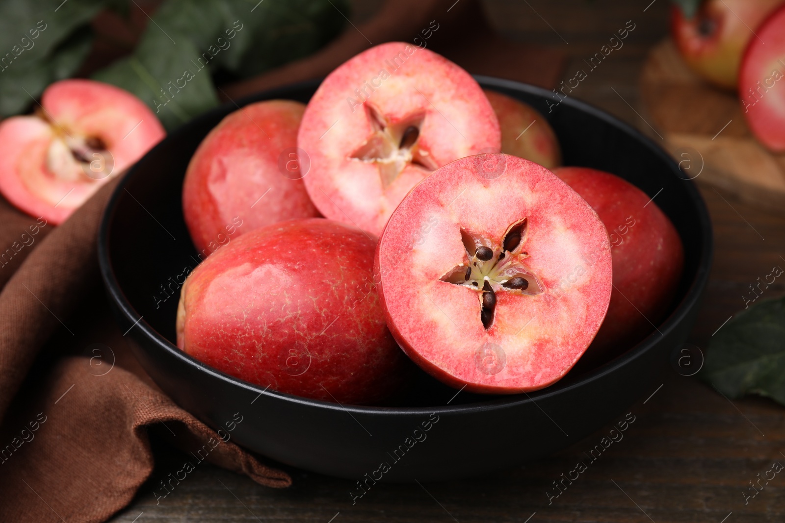 Photo of Tasty apples with red pulp on wooden table