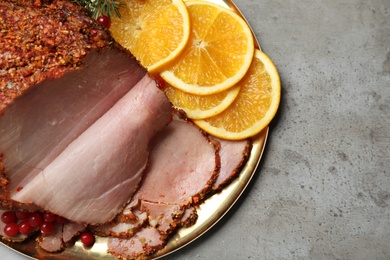 Photo of Delicious ham served for Christmas dinner on grey table, top view