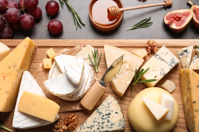 Photo of Flat lay composition with different types of delicious cheese on table