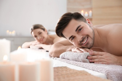 Photo of Romantic young couple relaxing in spa salon