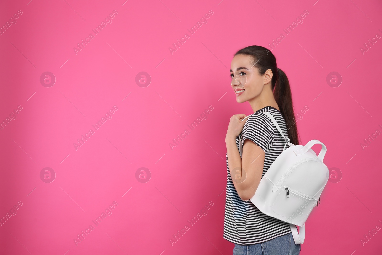 Photo of Beautiful young woman with stylish leather backpack on pink background. Space for text