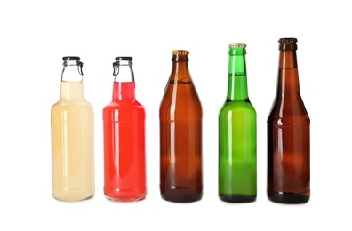 Photo of Bottles with different alcoholic drinks on white background