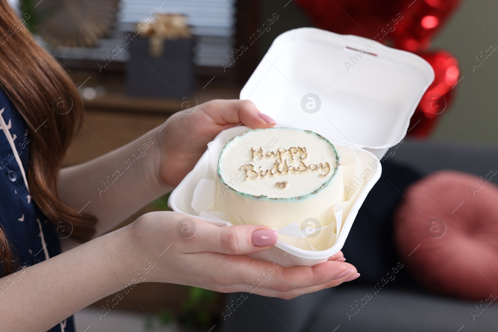 Photo of Woman holding her Birthday cake indoors, closeup