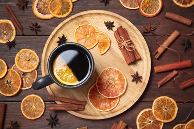 Composition with cup of mulled wine and ingredients on wooden table, flat lay