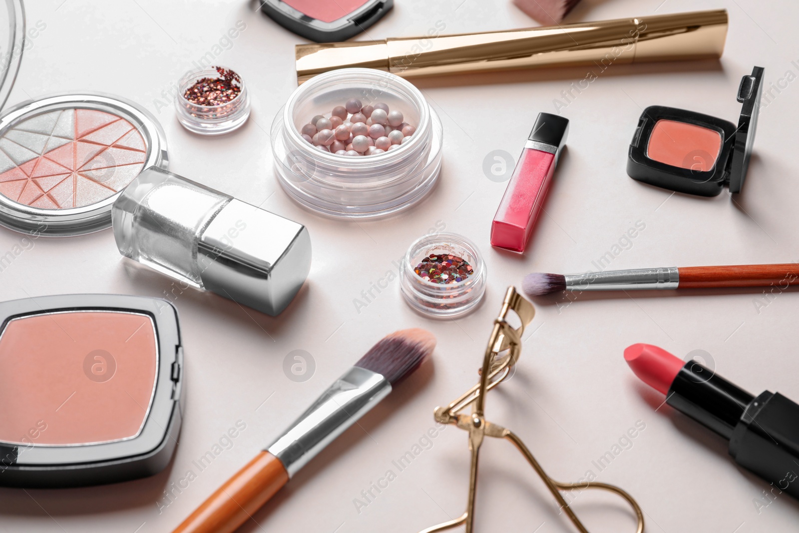 Photo of Decorative cosmetics and tools of professional makeup artist on color background