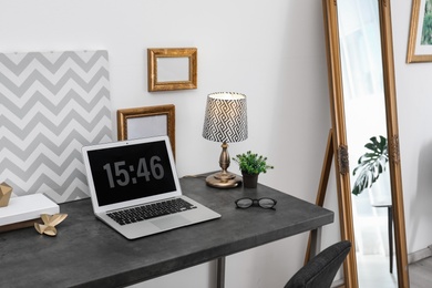 Stylish workplace with modern laptop on table indoors