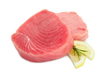 Fresh raw tuna fillets with lemon slices and rosemary on white background