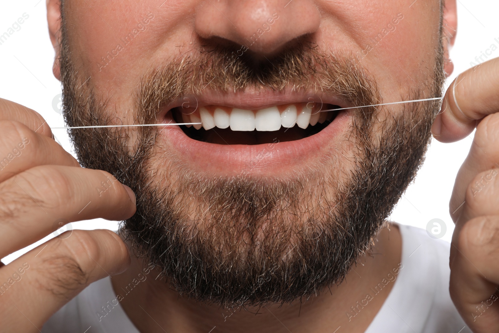 Photo of Man flossing his teeth on white background, closeup. Dental care