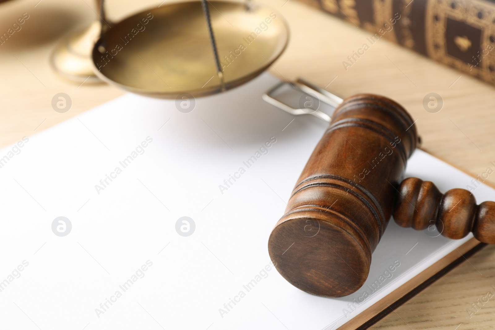 Photo of Clipboard with words DOMESTIC VIOLENCE and gavel on wooden table, closeup