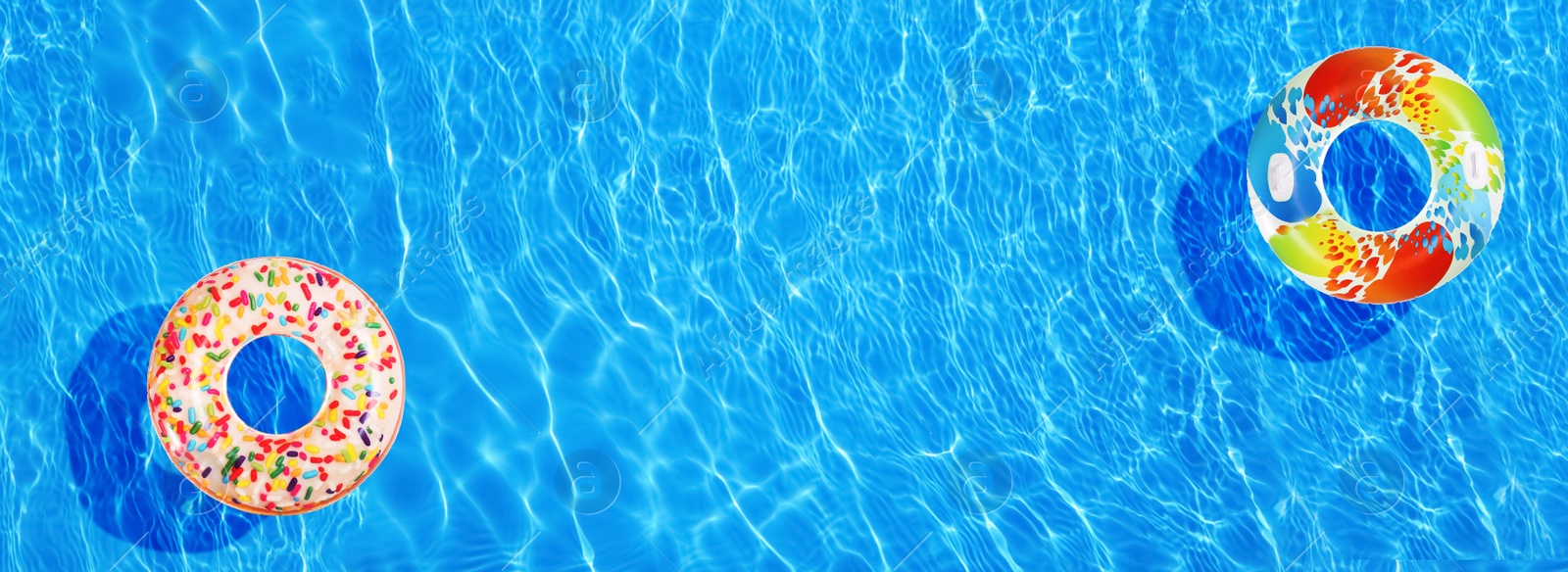 Image of Different inflatable rings floating in swimming pool, top view. Banner design