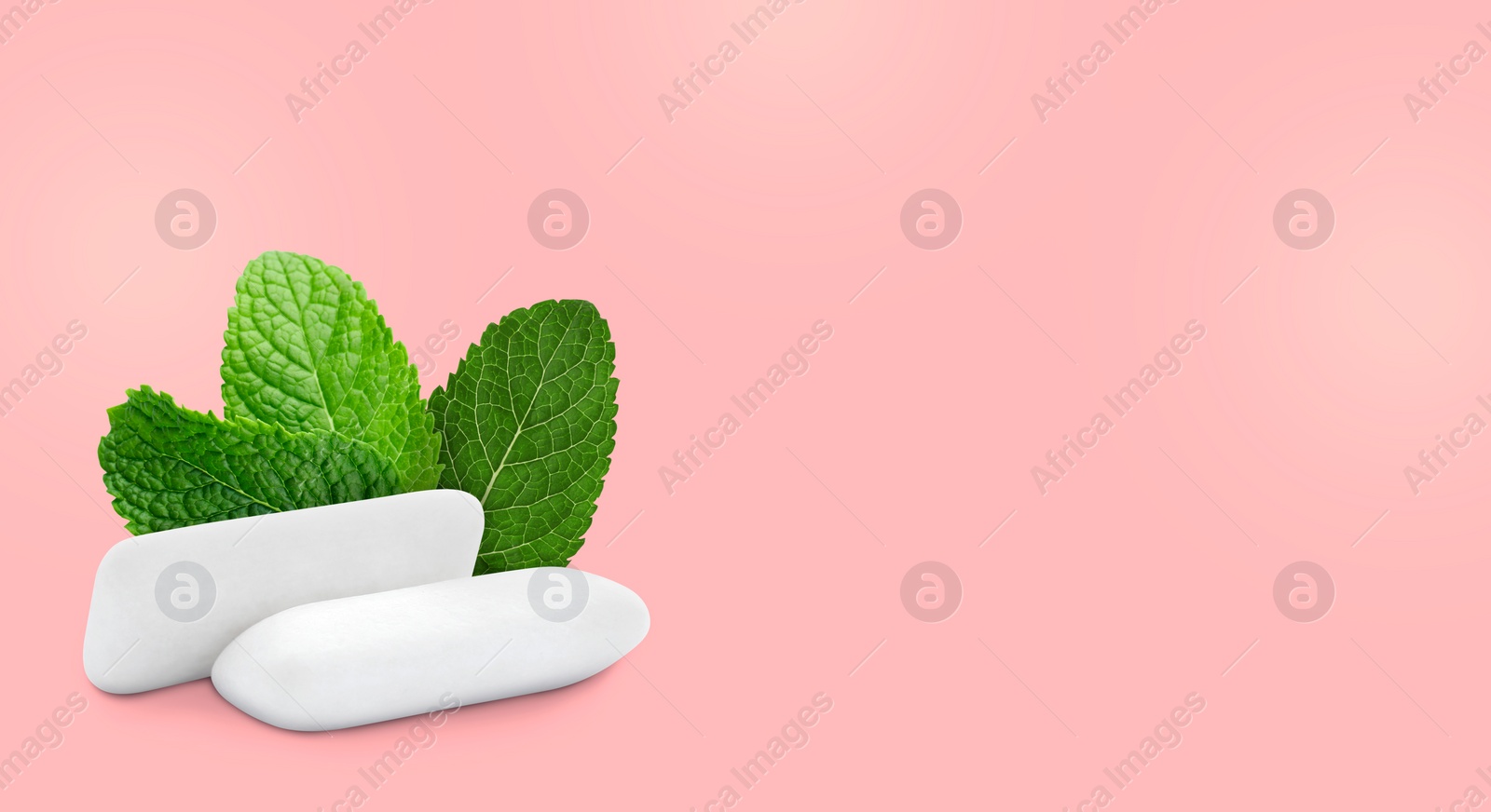 Image of Menthol chewing gum pillows and mint leaves on pink background, space for text. Banner design