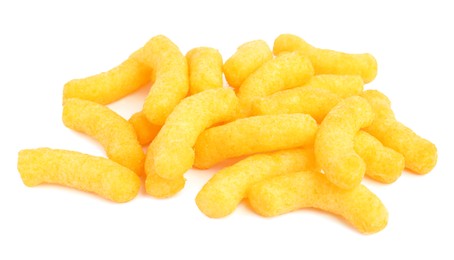 Many tasty cheesy corn puffs isolated on white