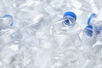 Photo of Pile of crumpled plastic bottles as background, closeup. Recycling problem