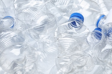 Pile of crumpled plastic bottles as background, closeup. Recycling problem