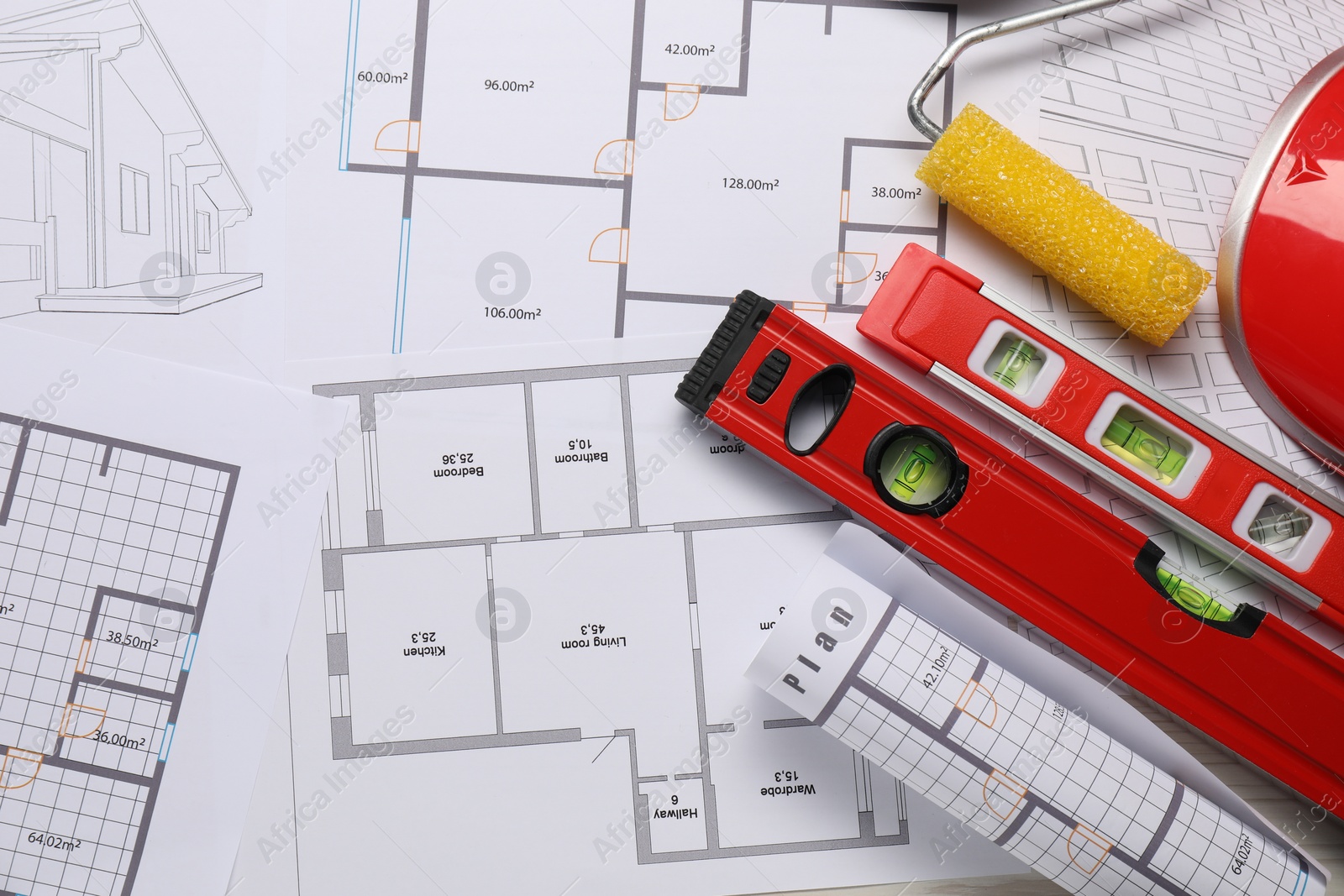 Photo of Flat lay composition with building level and other construction tools on papers