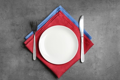 Photo of Patriotic table setting with traditional USA colors on grey background, top view