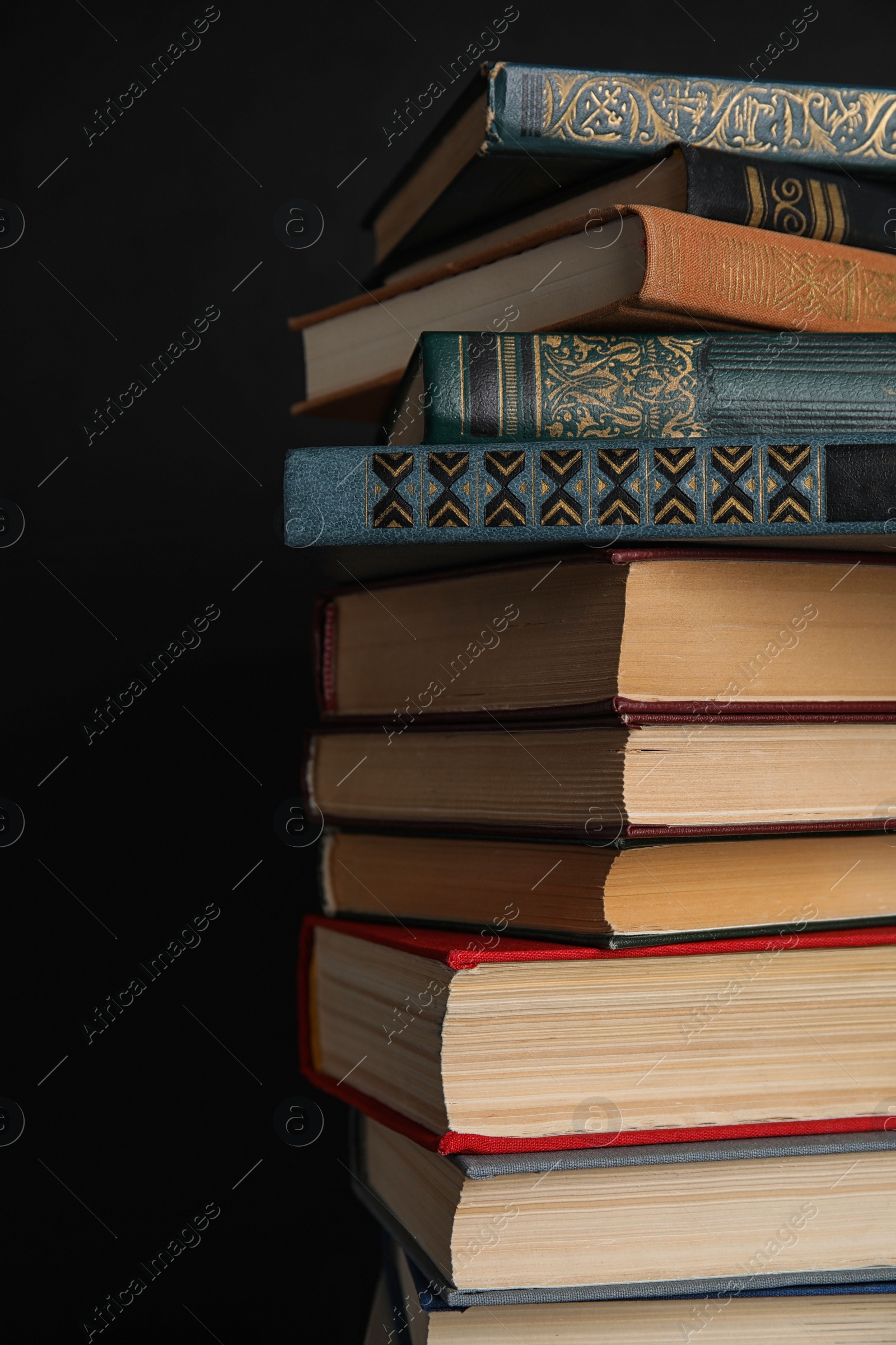 Photo of Stack of hardcover books on black background