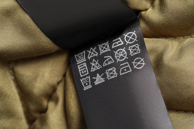 Photo of Clothing label on beautiful garment, closeup view