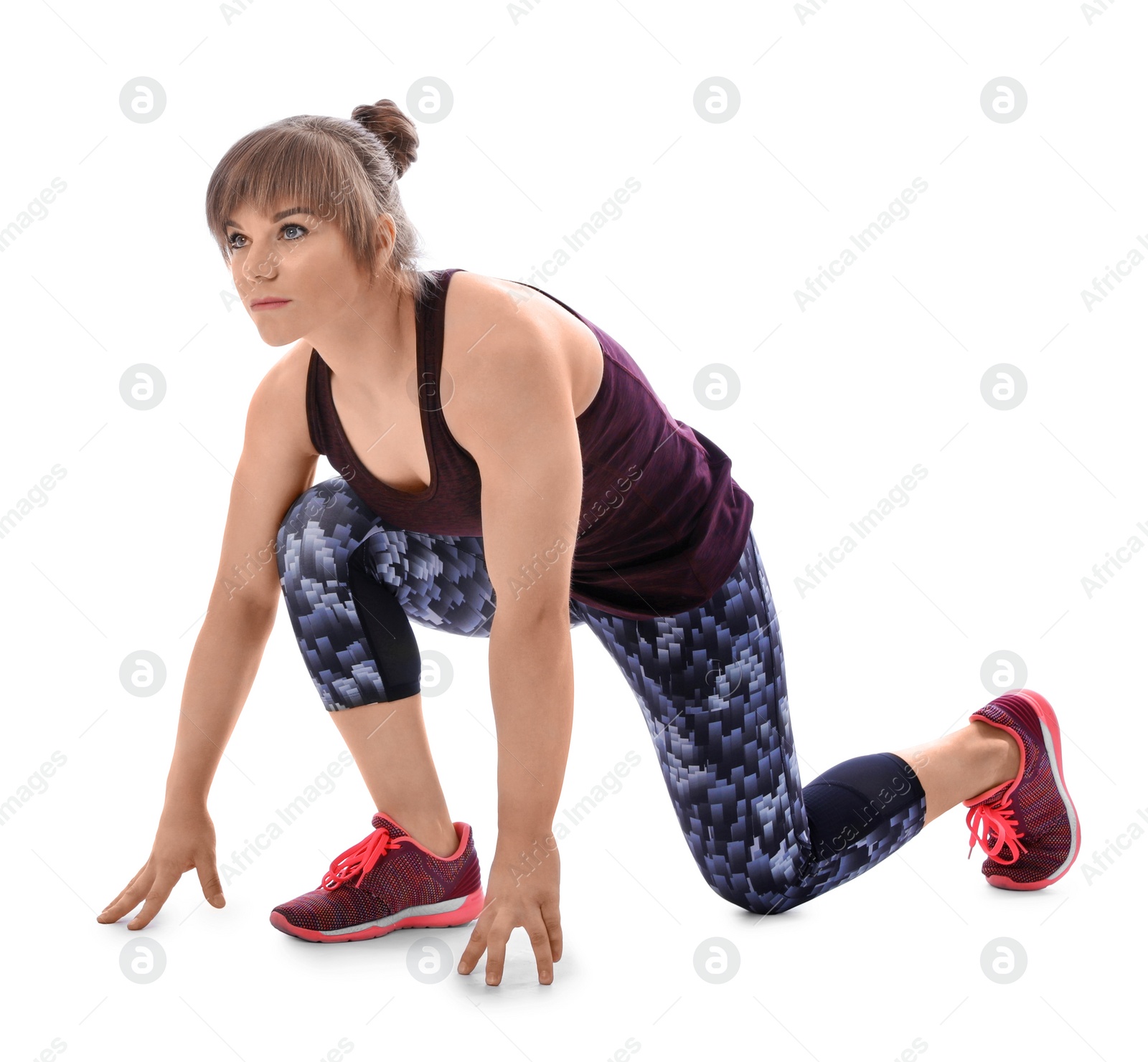 Photo of Young woman ready to run on white background