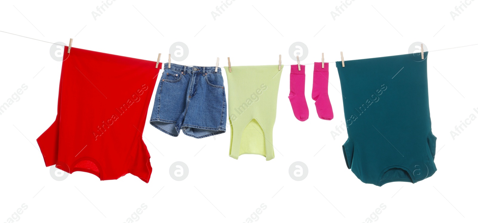 Photo of Different clothes drying on laundry line against white background