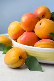 Photo of Delicious fresh ripe apricots on white table