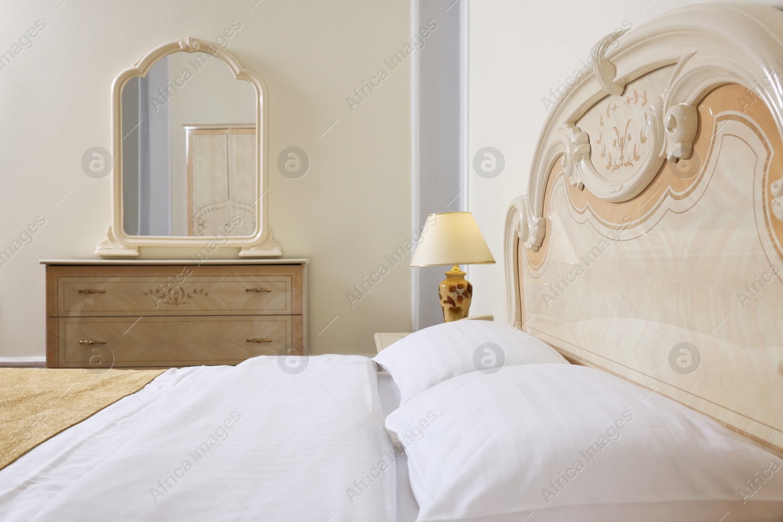 Photo of Stylish bedroom interior with comfortable bed and mirror