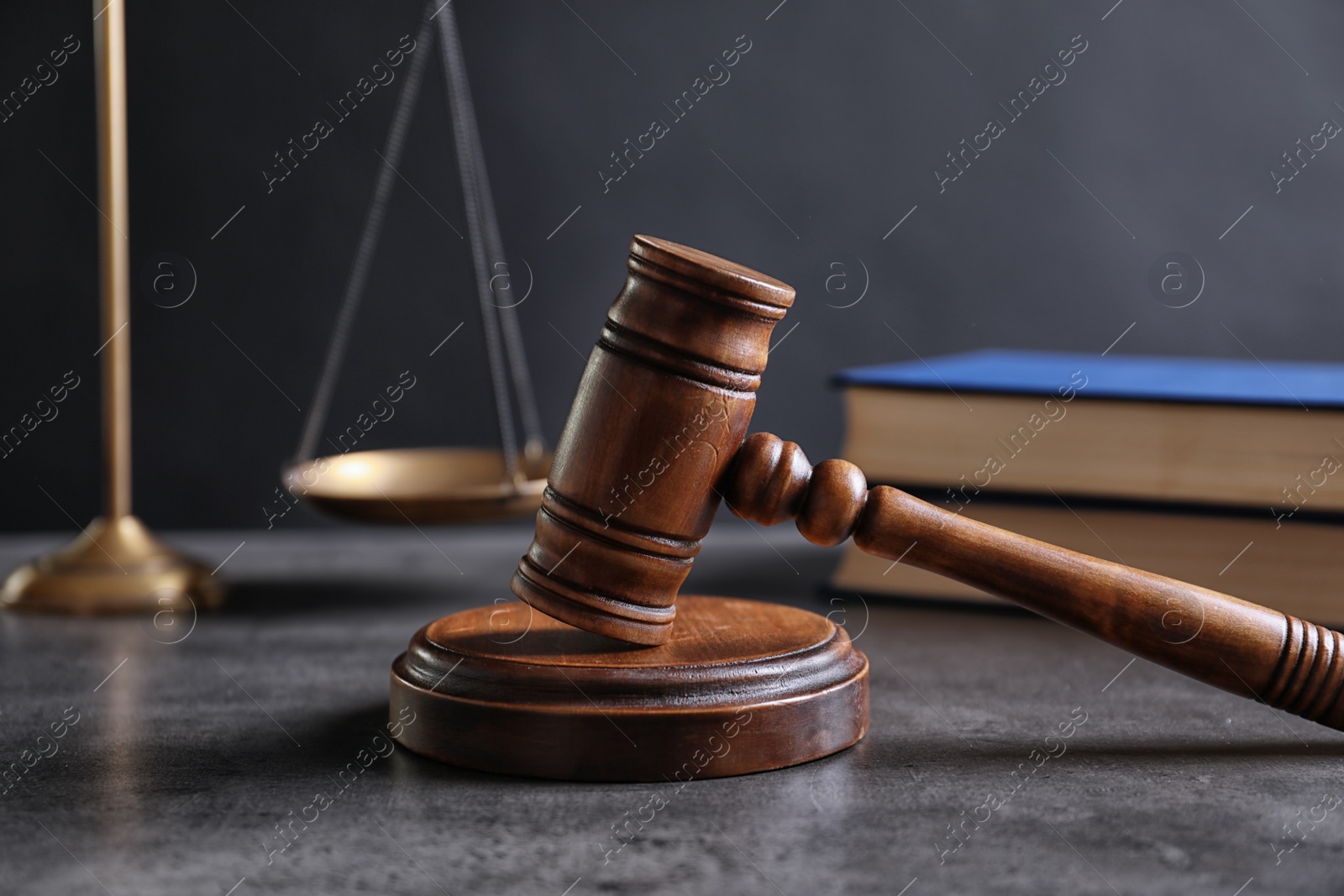 Photo of Judge's gavel and blurred scales on background. Law concept