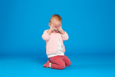 Photo of Cute little child on light blue background