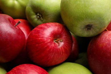 Photo of Ripe red and green apples as background, closeup