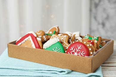 Photo of Box with tasty homemade Christmas cookies on table