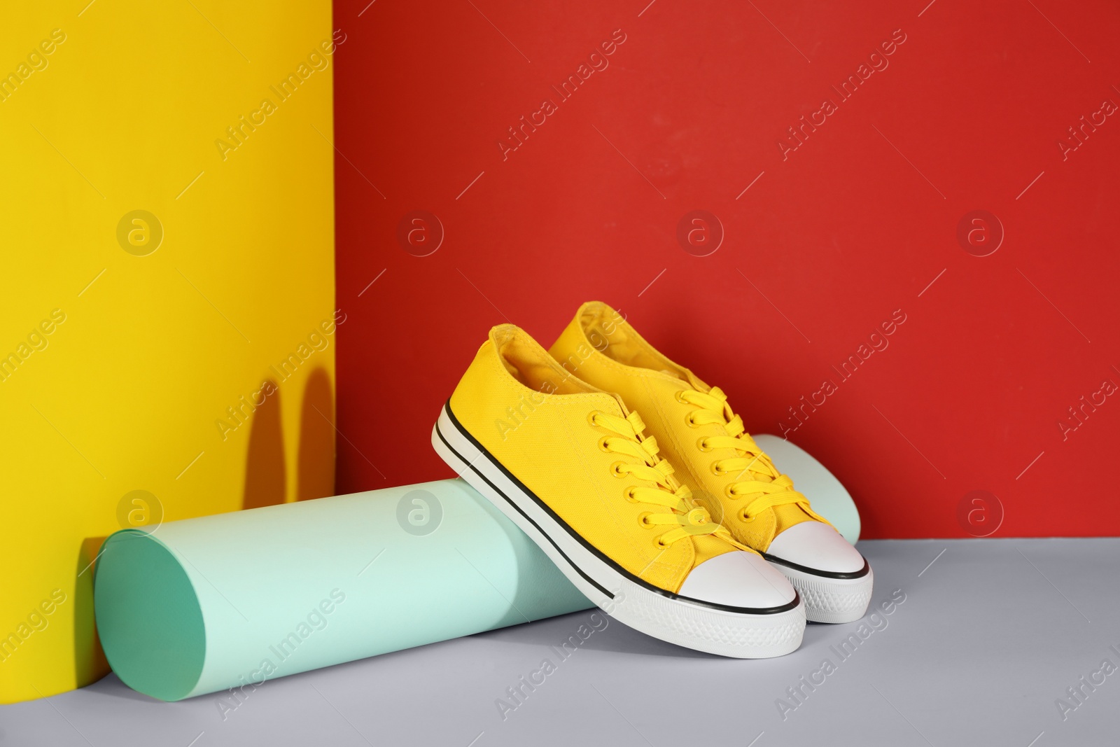 Photo of Pair of stylish sneakers on color background