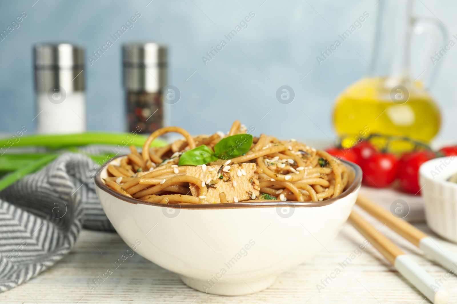 Photo of Tasty buckwheat noodles with meat served on white wooden table