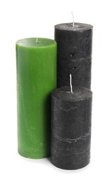 Different decorative wax candles on white background