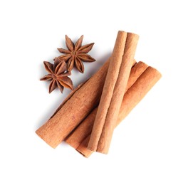 Photo of Cinnamon sticks and anise stars isolated on white, top view