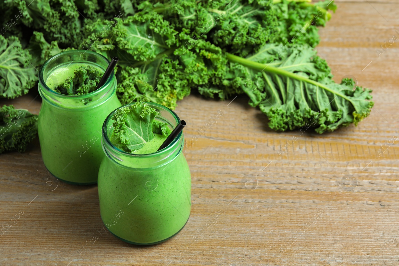 Photo of Tasty fresh kale smoothie on wooden table