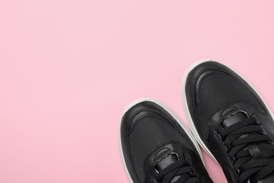 Photo of Pair of stylish shoes on pink background, top view. Space for text