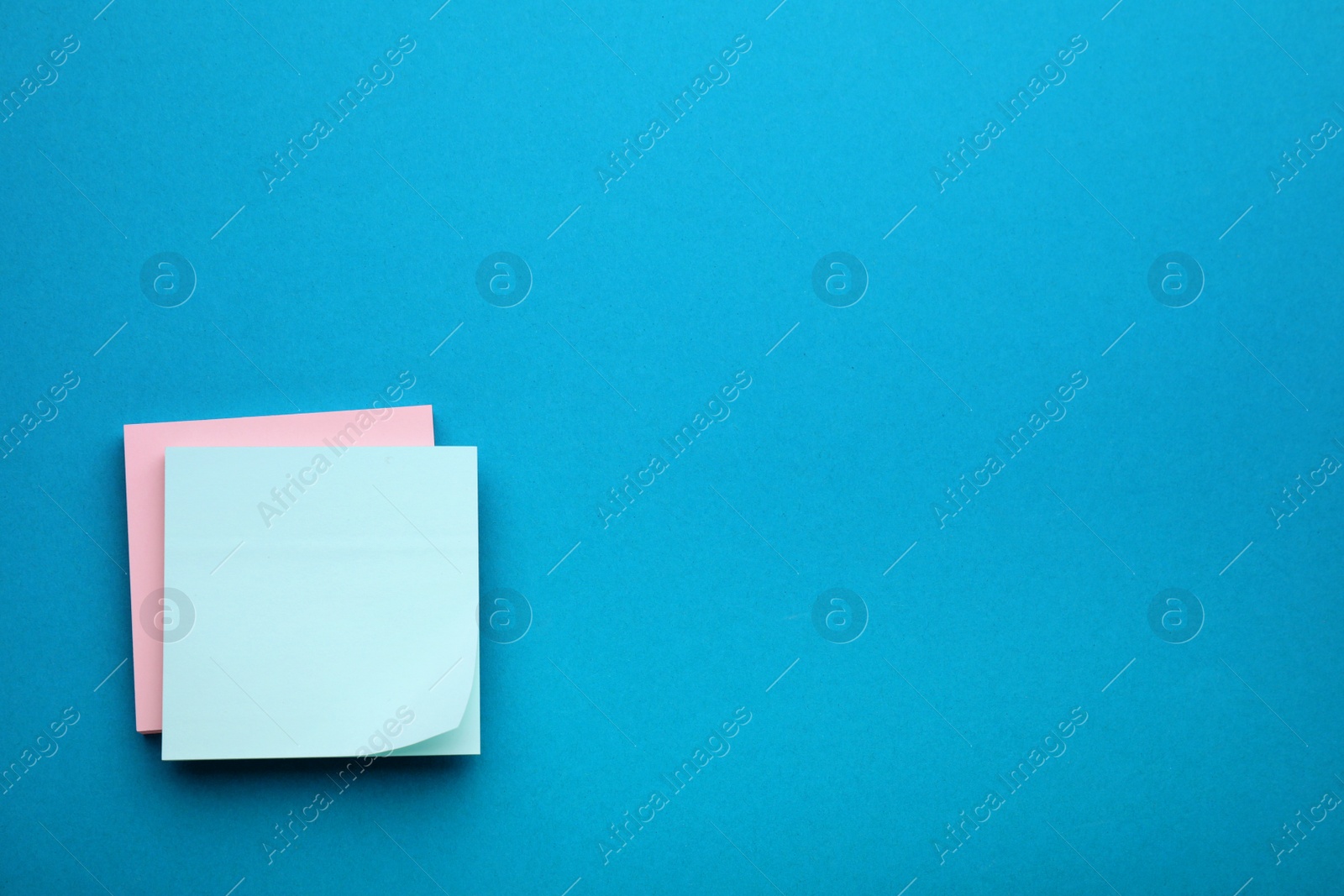 Photo of Paper notes on blue background, top view