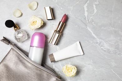 Flat lay composition with natural female  deodorant and cosmetics on grey marble table