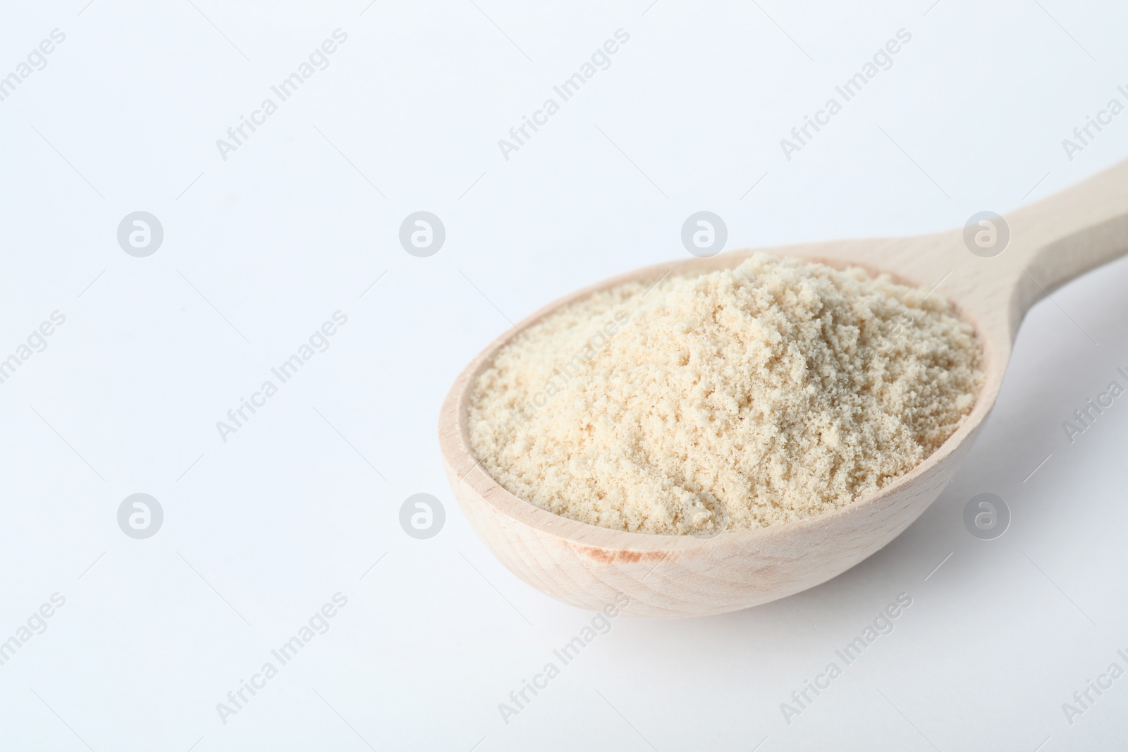 Photo of Spoon of sesame flour isolated on white. Space for text
