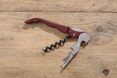 One corkscrew (sommelier knife) on wooden table, top view