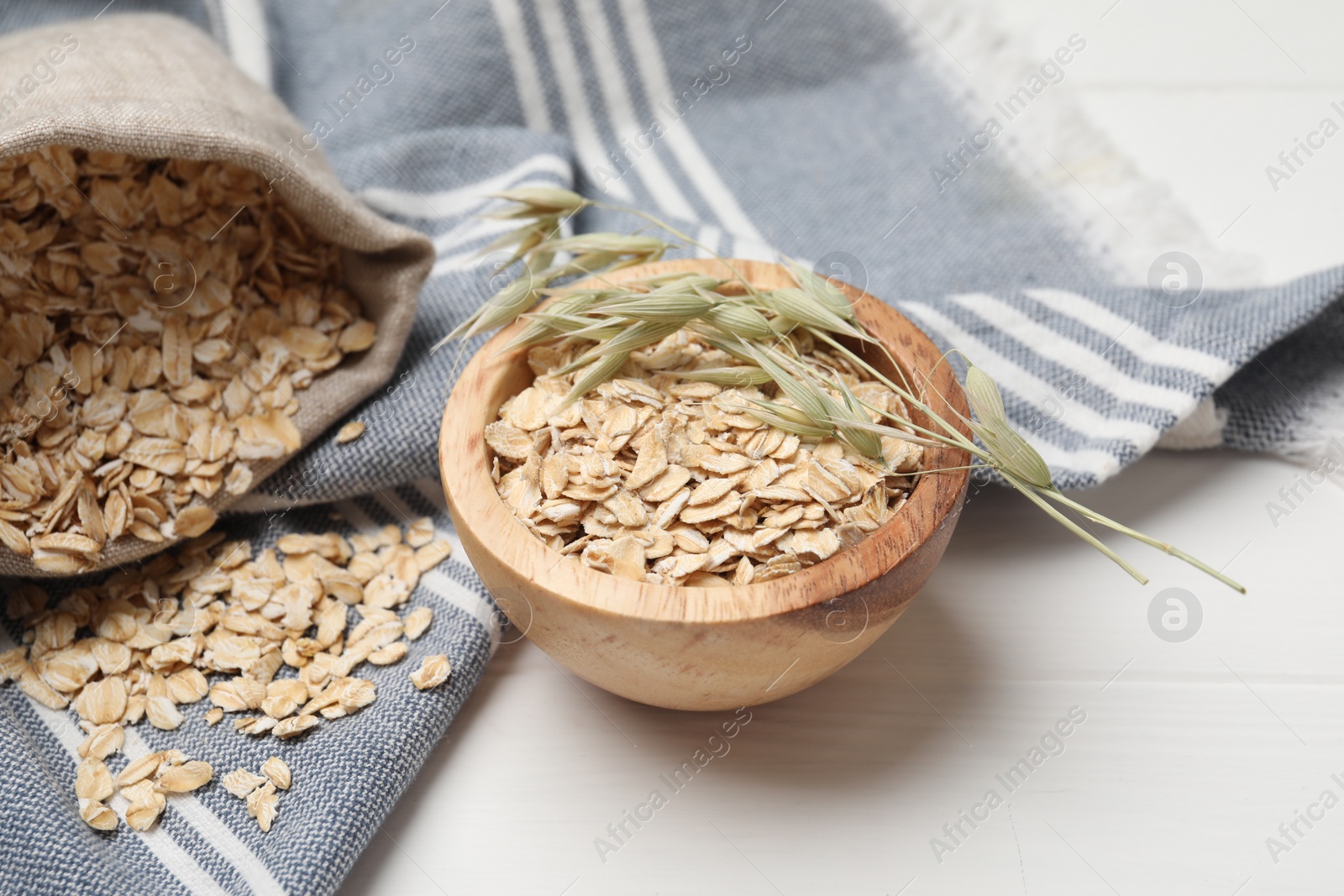 Photo of Oatmeal and florets on white wooden table