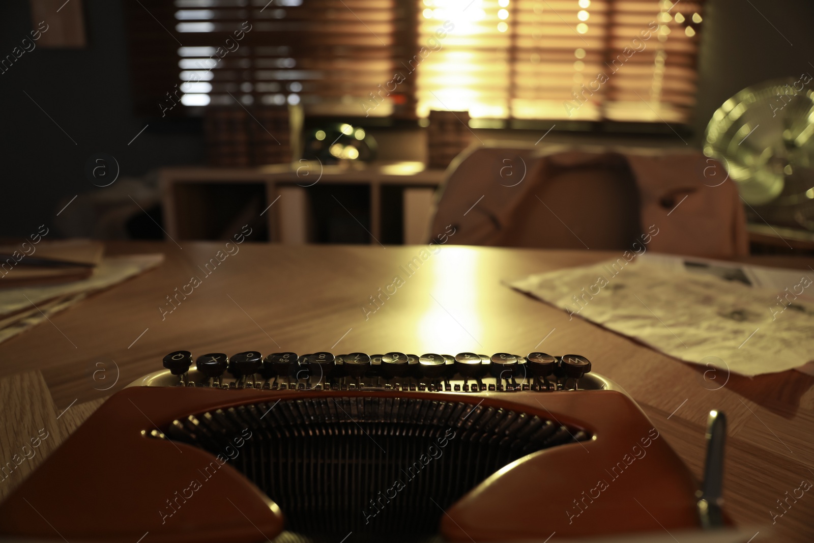 Photo of Detective workplace with vintage typewriter on wooden table