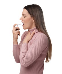 Woman using throat spray on white background