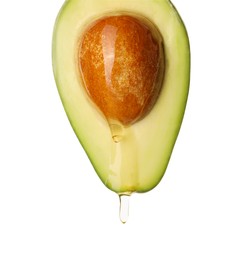Photo of Fresh cut avocado with dripping cooking oil on white background