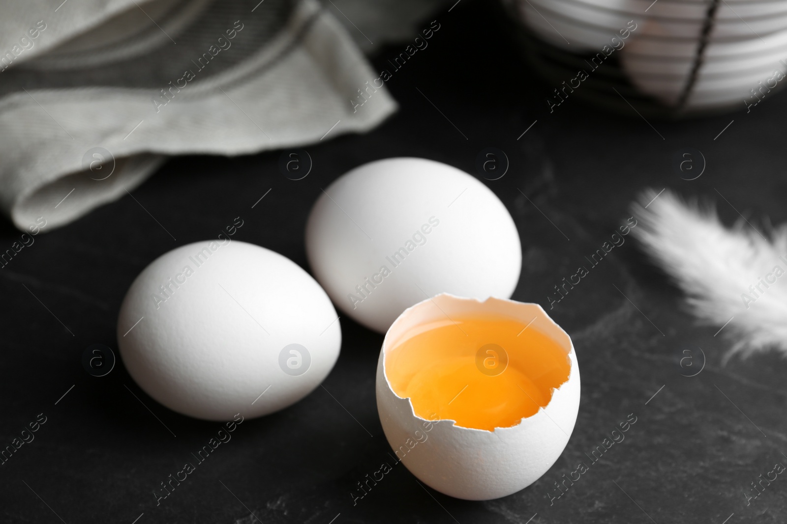 Photo of Fresh raw chicken eggs on black table