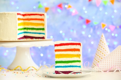 Photo of Delicious rainbow cake for party on table