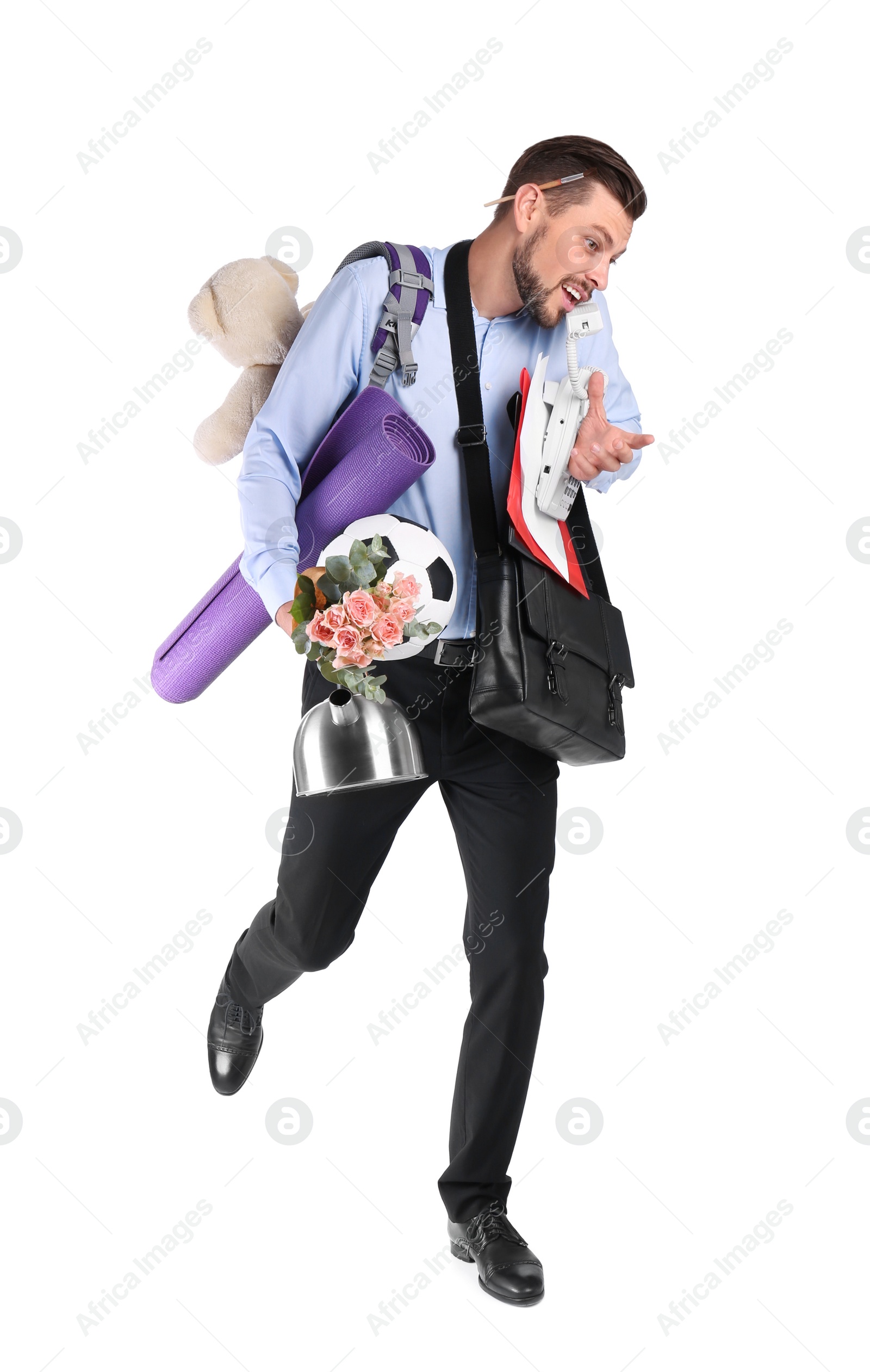 Photo of Businessman with lots of things running while talking on phone against white background. Combining life and work