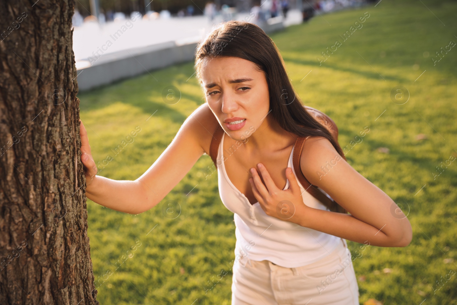 Photo of Young woman having heart attack in park