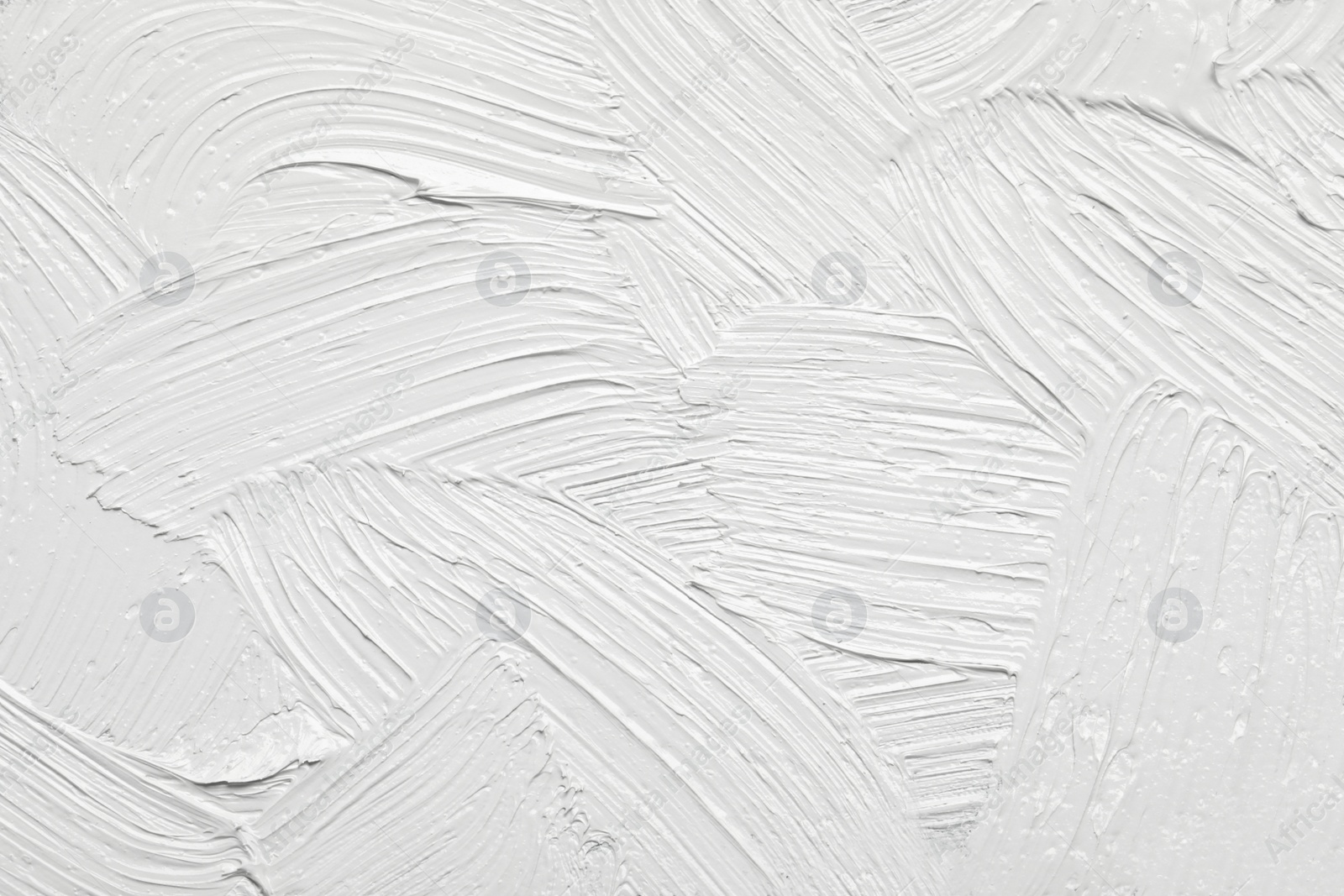 Photo of Strokes of white oil paint as background, closeup